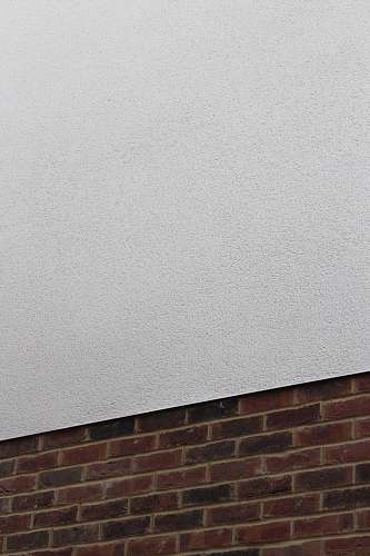 rug red brick wall and plain white concrete wall wall