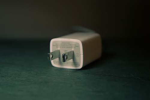 plug shallow focus photography of white travel adapter charger