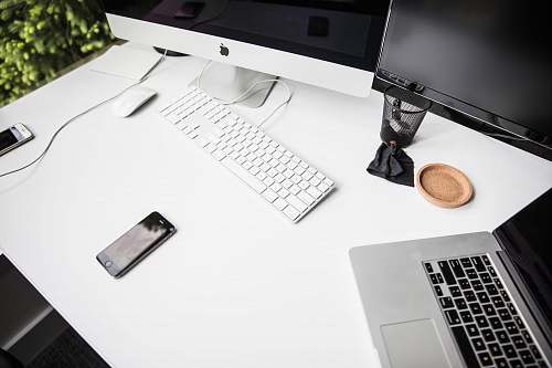 computer space gray iPhone 6 on table near magic keybord laptop