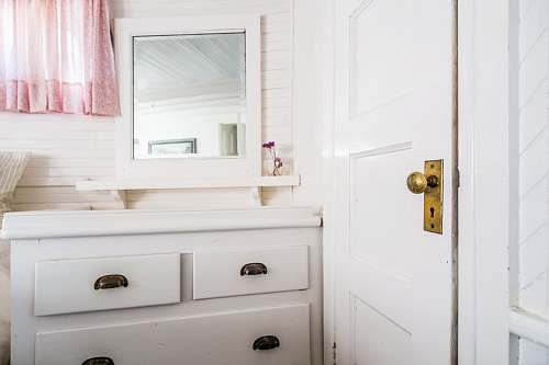 interior white wooden door near wooden dresser home