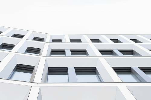 building worm's eyeview photo of white concrete 3-storey building window