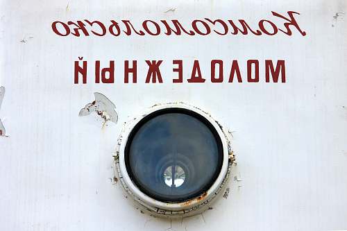 porthole gray telephoto lens with text overlay wristwatch