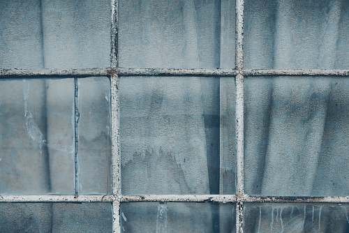 grey grey metal grill on clear glass window closeup photography window pane