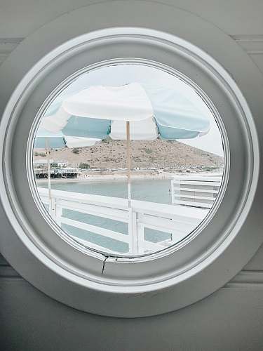 blue white and gray striped patio umbrella porthole