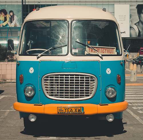 human blue classic van parked on parking lot during day person