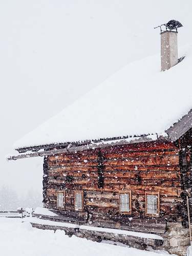 snow brown wooden house filled with snow during snow snowing