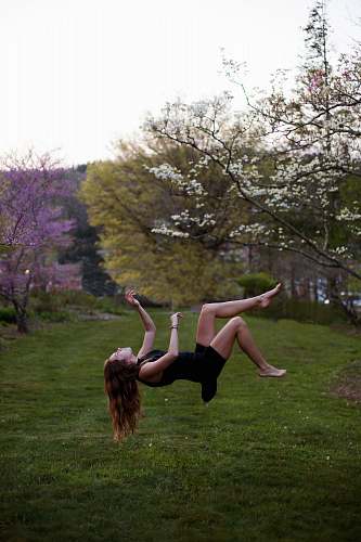 girl woman back flipping in the garden spring