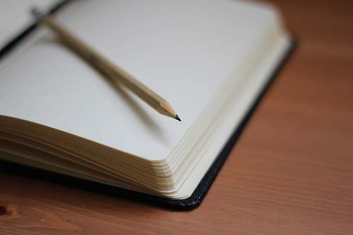 book shallow focus photography of pencil on book notebook