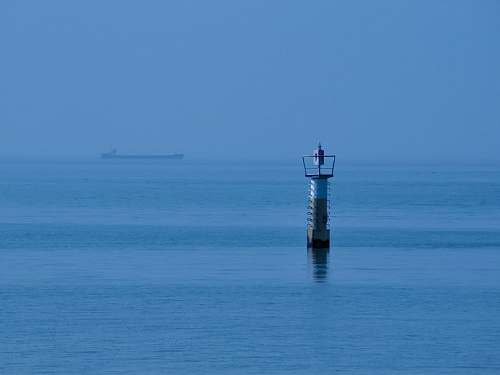 building white and brown tower on calm sea tower