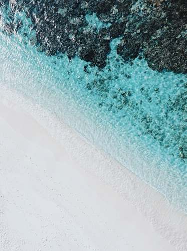 water high-angle photography of beach side ocean