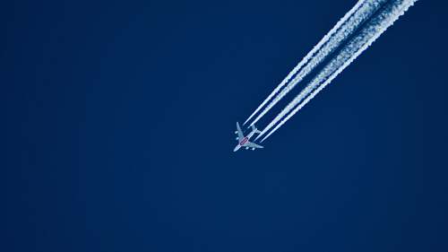 airplane aerial photo of airplane with contrail during daytime aircraft