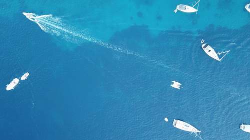outdoors aerial photo of powerboats in ocean water