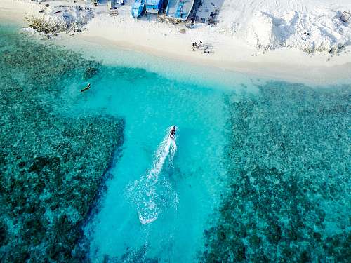 maldives aerial photography of boat on ocean during daytime sea