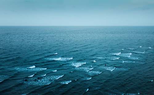 waves aerial photography of body of water ocean