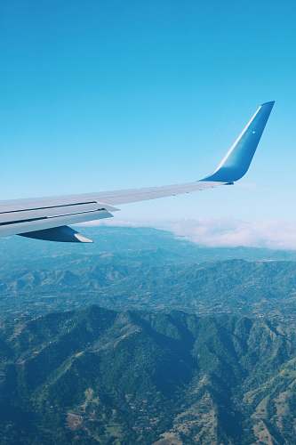aircraft aerial photography of mountain during daytime airplane