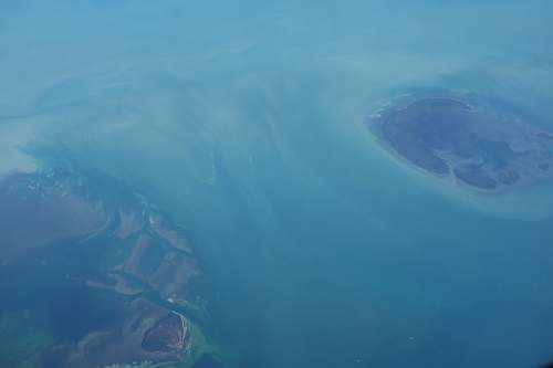 water aerial photography of mountains caribbean sea