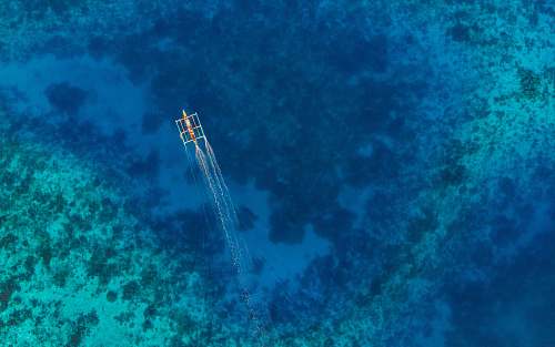 nature aerial-view photography of boat on sea water