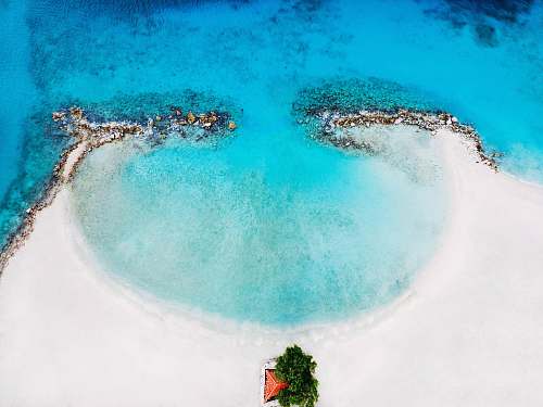 ocean bird's eye view of naked island beach