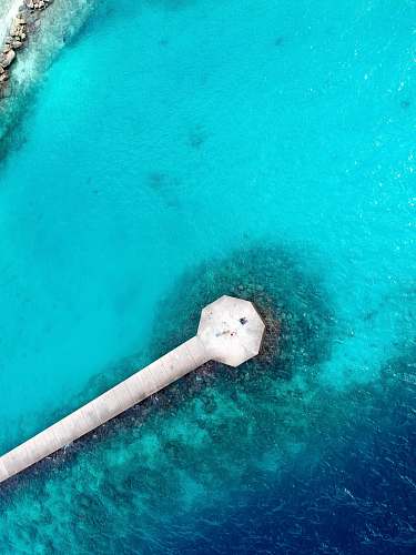 teal bird's eye view of sea dock aerial