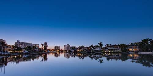 water body of water surrounded with buildings lake