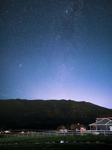 night brown houses in front of hill under starry night android wallpapers