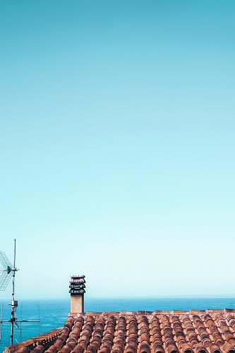 architecture brown roof shingles under calm blue sky building