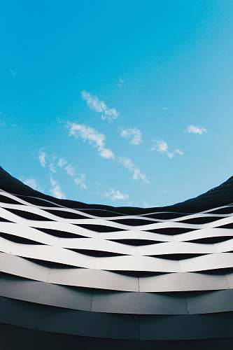 architecture building under white clouds and blue sky during daytime building