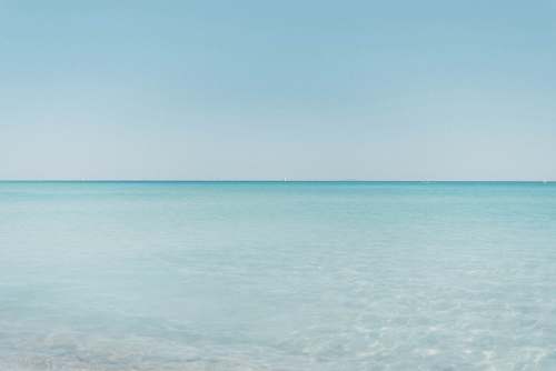 outdoors calm sea water during daytimee horizon