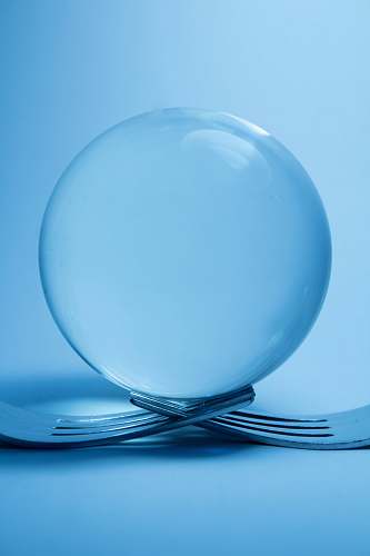 sphere clear glass ball on top of two forks ball