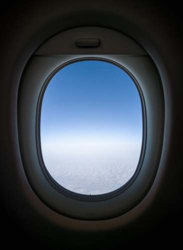 window clear white skies from plane's window view porthole