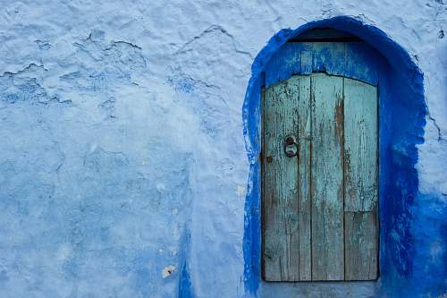 door close-up photography of concrete house chefchaouen