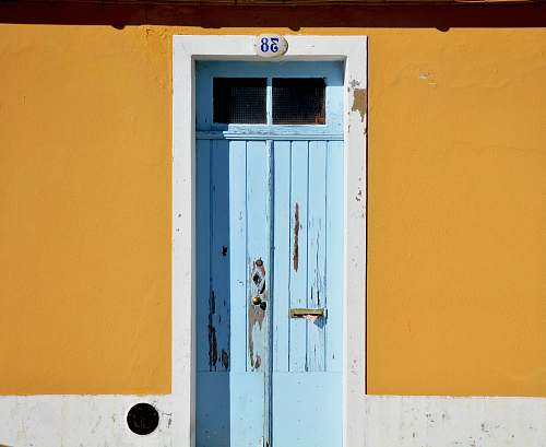 yellow closed blue wooden door door