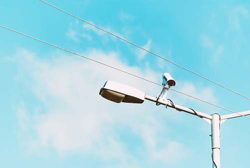 greece closeup photo of white lamp post and camera camera