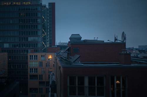 building high rise buildings under gray clouds at nighttime hamburg