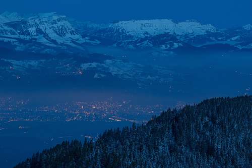 outdoors lighted house in city near glacier mountain at nighttime mountain