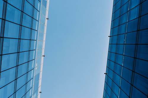 building low angle photography of curtain wall building at day time housing