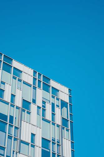 building low angle photography of white and teal painted building housing