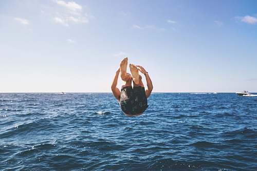 ocean man back tumbling during daytime sea