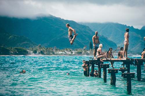 water man diving from dock with people people