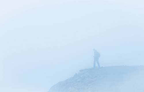 nature man on a foggy cliff fog