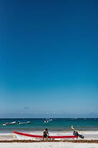 human man sitting on motorboat in beach person