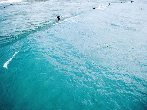 beach man standing on paddleboat surfer
