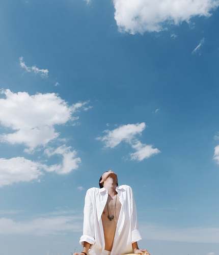 clothing man wearing white dress shirt looking up apparel