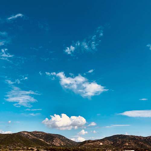 nature mountains under blue skies during daytime outdoors