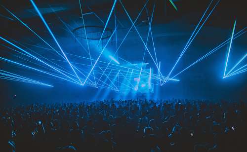 light people partying under blue lights laser