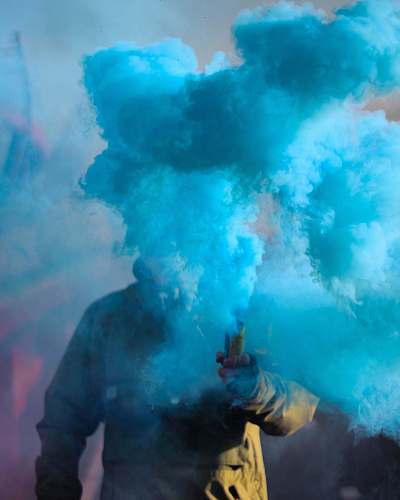 smoke person holding stick with blue smoke color