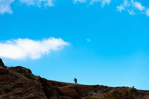 nature person on incline land terrain during daytime outdoors