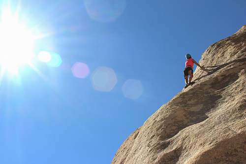 sport person rock climbing during day time climbing