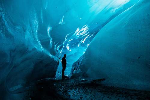 nature person standing in ice cave at daytime iceland