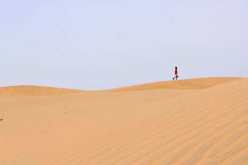 sand person walking on desert desert